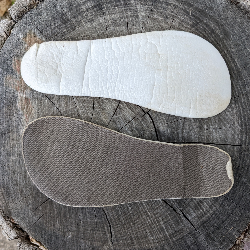 A pair of original insoles from Be Lenka Barefoot kids shoes. They are thin and curled/wrinkled in places