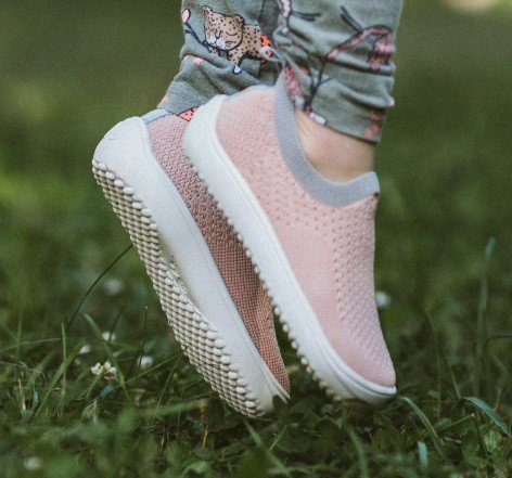 Be Lenka Barefoot Perk stretchy knit extra wide kids barefoot shoe in pink being worn while jumping