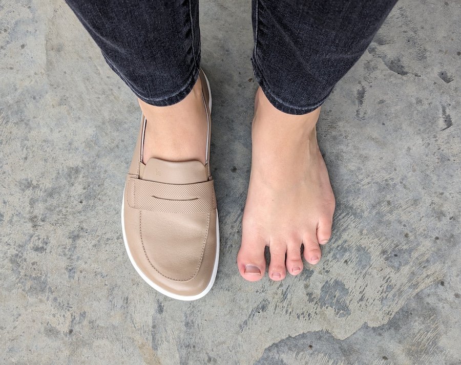 Top down view of a person with extra wide feet wearing 1 Be Lenka Buena barefoot loafers while the other foot is bare to show the shape match.