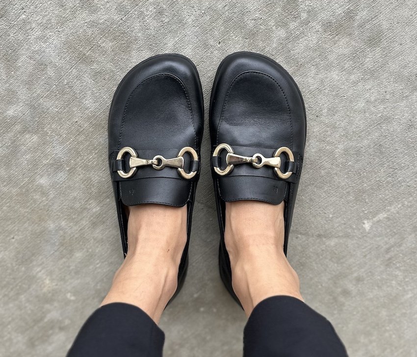 a top down view of a pair of Be Lenka Viva barefoot loafers in black with a gold horsebit metal buckle, a stylish women's barefoot dress shoes