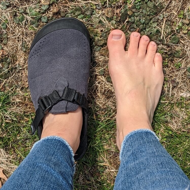 Top Down view of one Bedrock Mountain Clog next to a bare extra wide sloped shape foot with high volume