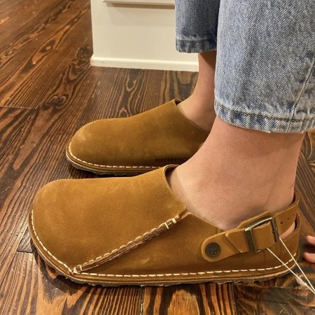 Side close up view of a person wearing Birkenstock Lutry barefoot clogs