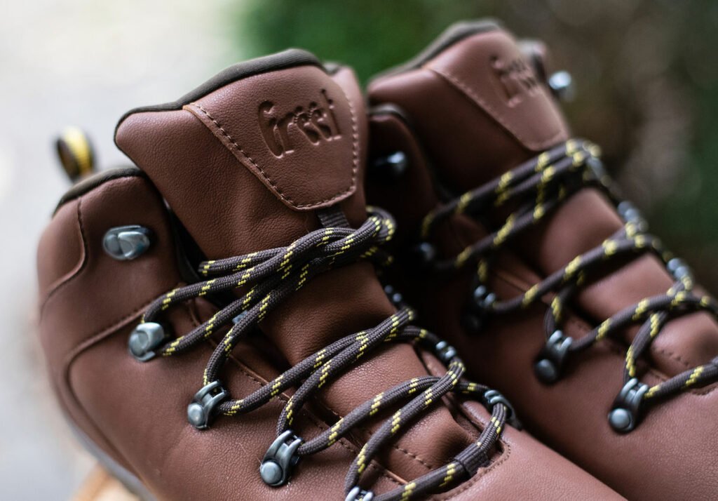 A close up of the loogo on a pair of Freet Mudee Barefoot vegan hiking boo