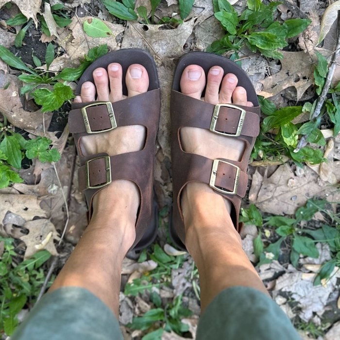 Freet Barefoot two strap barefoot sandals being worn on leafy ground with dead leaves