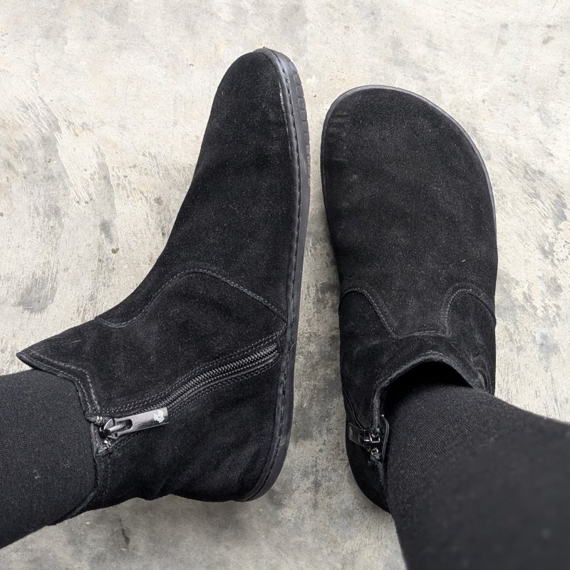 A top and side view of Groundies Camden Mid in Barefoot+ width showing the extra large toe box, zero drop outsole, and lower chelsea boot height in a beautiful black suede