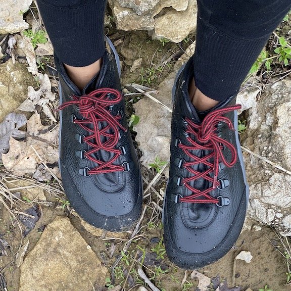 Top down view of Joe Nimble Wandertoes 2.0 being worn on a hike. The foot shaped wide toe box and red speed laces are visible.