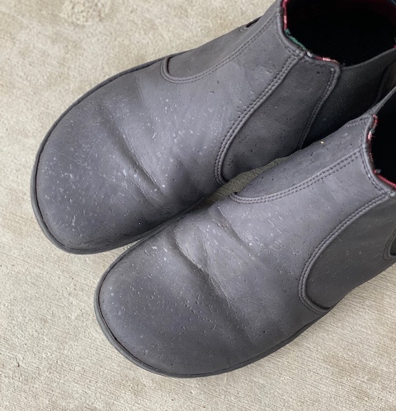 A pair of black cork Mukishoes vegan barefoot boots from the top down