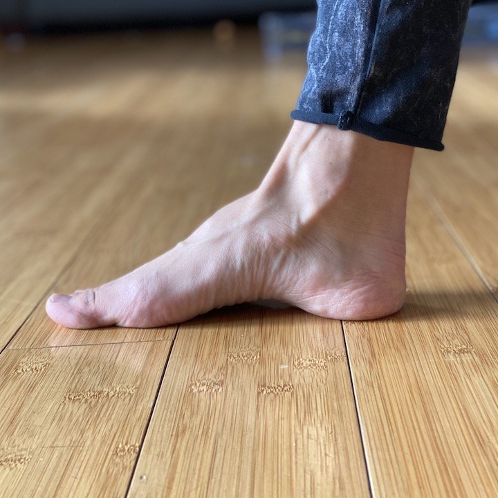 A close of up a woman's foot while she works her foot arch muscles doing exercises for foot function.