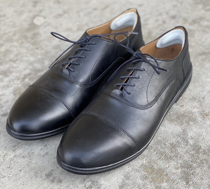 A close up angled view of the best dressy barefoot shoes for men. Caret's brand.