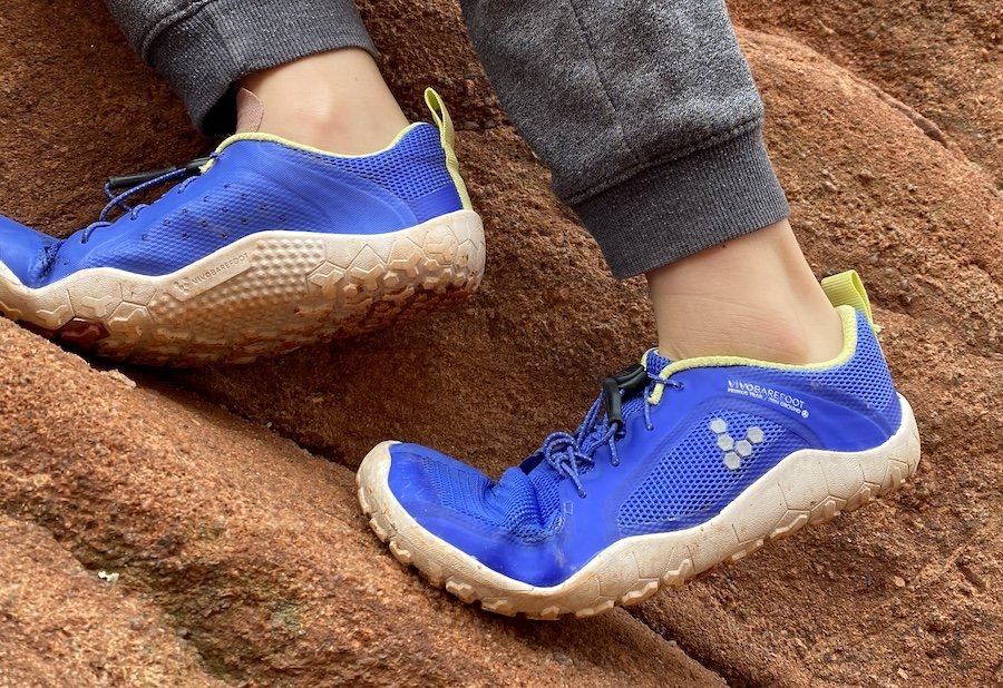 Close image of a pair of kids Vivobarefoot Primus Trail hiking shoes with a wide toe box and flexible sole