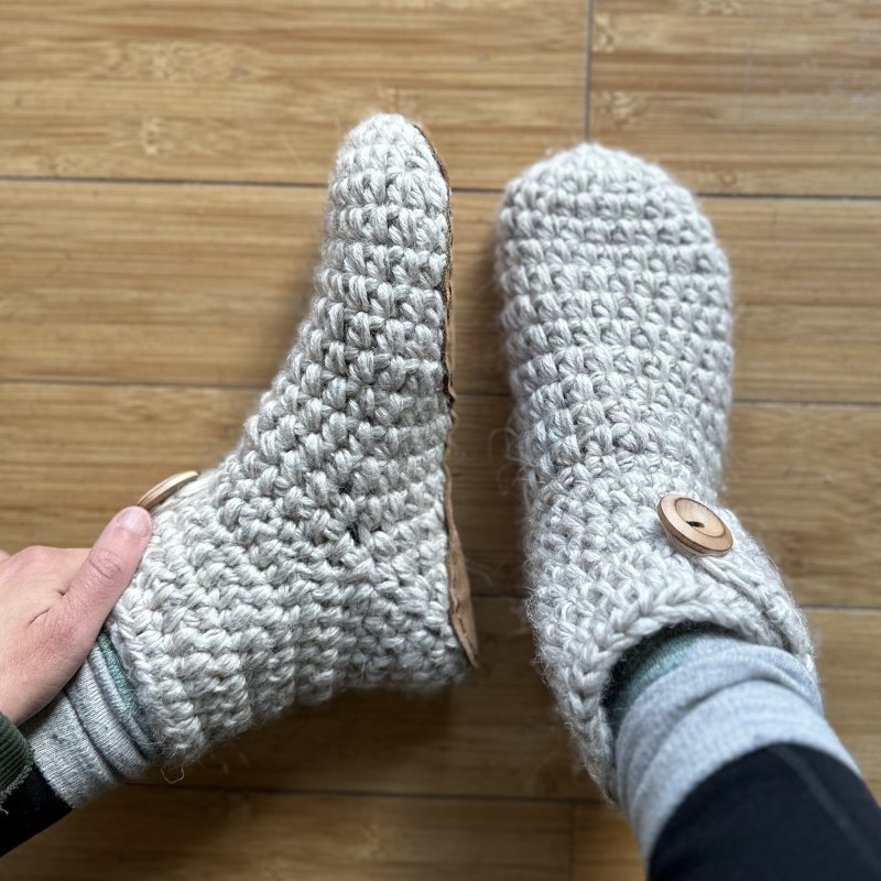A pair of feet showing the top down and side view on high top Kingdom of Wow barefoot friendly indoor slippers