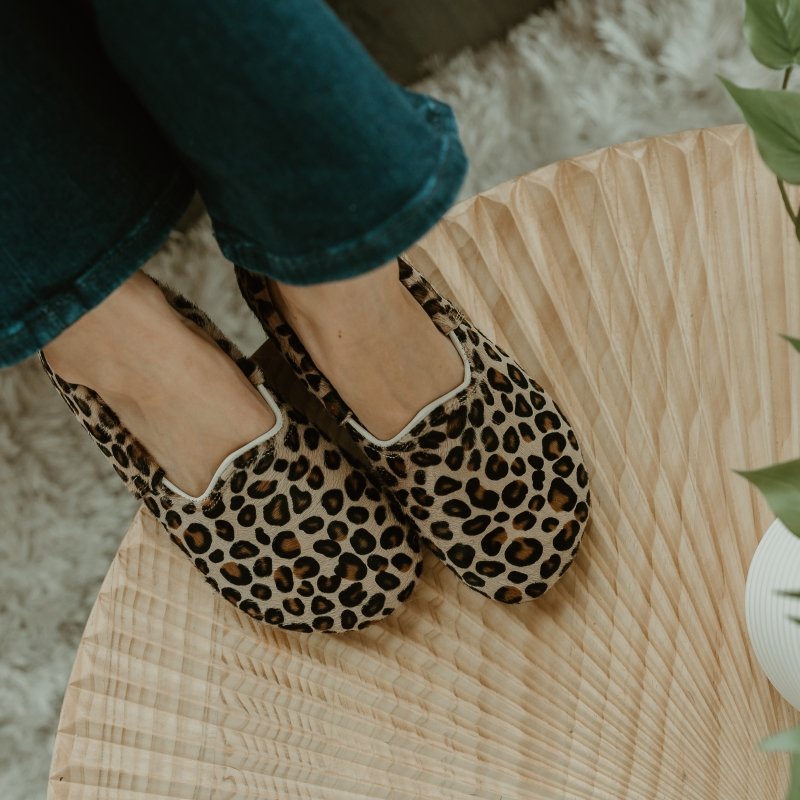 Top down view of Anya's Shop Yasemin Loafers in Leopard leather resting on a textured tabletop