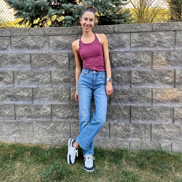 A woman in a tank top, Madewell 90s Straight jeans, styled with Barebarics Wave barefoot wide toe box sneakers