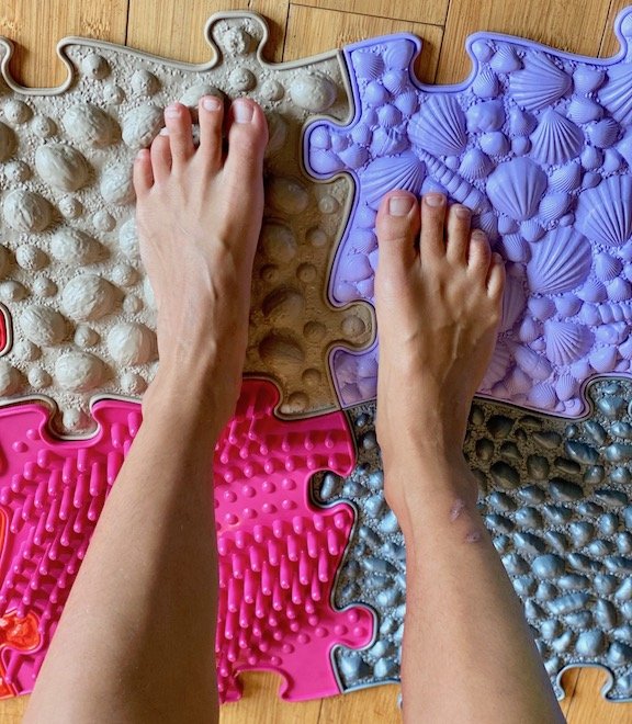 A woman's feet standing on Muffik Orthopedic Floor mats