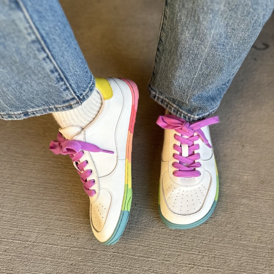 Close up top and side of funky barefoot sneakers from PaperKrane with rainbow neon outsoles and bright pink laces.