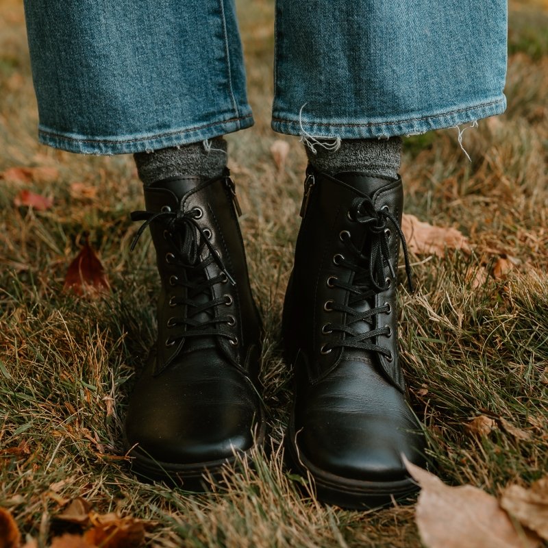Front close up view of Peerko Go black leather lace up combat style boots with a side zipper, wide toe box, and flexible zero drop outsole