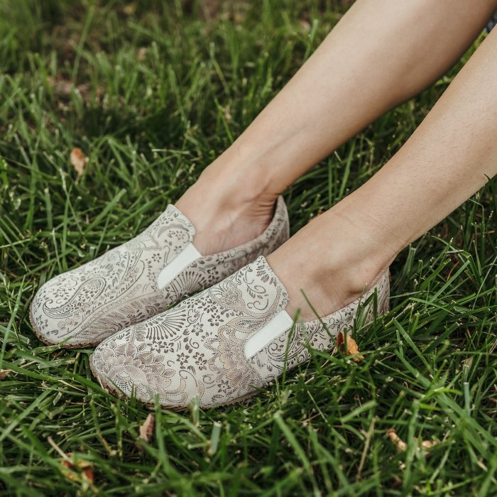 A pair of Peerko Trim Paisley print loafers sitting on the grass