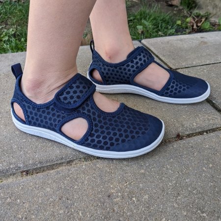 A child wearing navy blue Reima Rantaan barefoot budget friendly inexpensive summer sandals