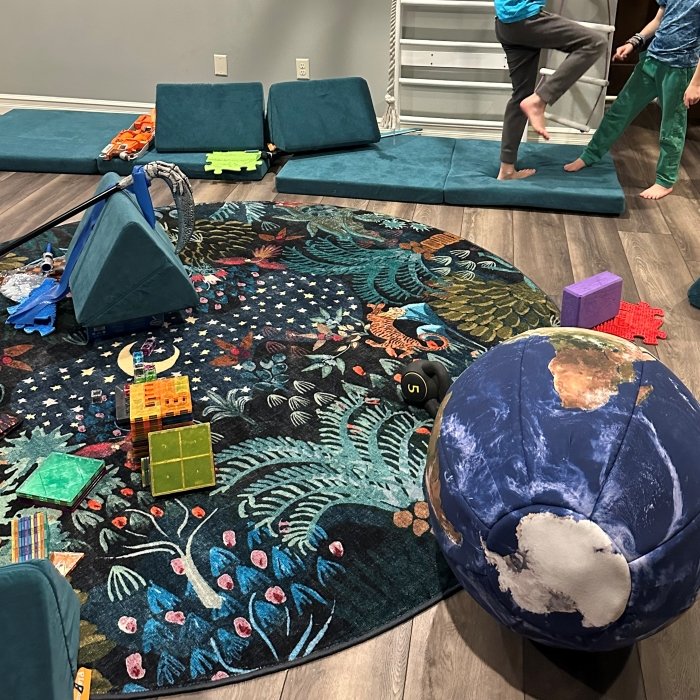 A colorful array of movement accessories including a Ruggable washable round rug