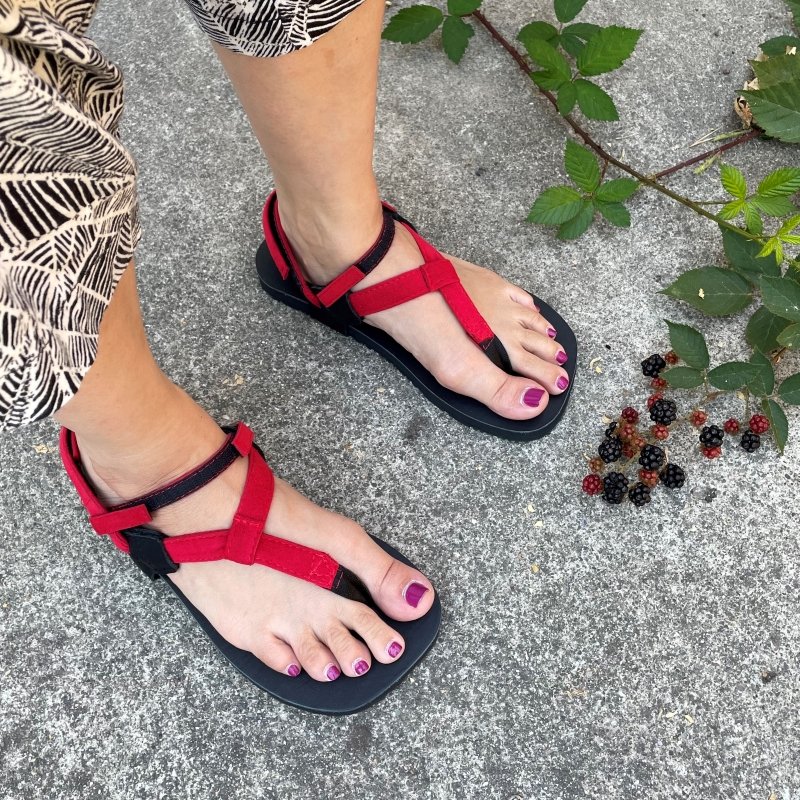 Toetem sandals, made in the USA, in red being worn by a woman.