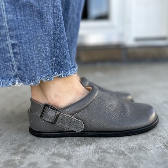 Side profile close up view of Tomar Creation barefoot leather clogs with optional back strap on a flexible zero drop outsole