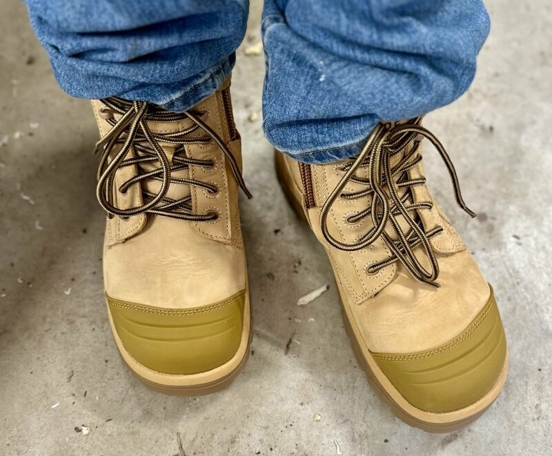 A pair of tan Wide Load extra wide high volume composite toe work boots that are lightweight with an easy on/off zipper.