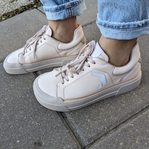 Close up side staggered view of a woman's sneakers from Wyde Footwear. The chunky wide toe box shoes have a flat zero drop outsole.