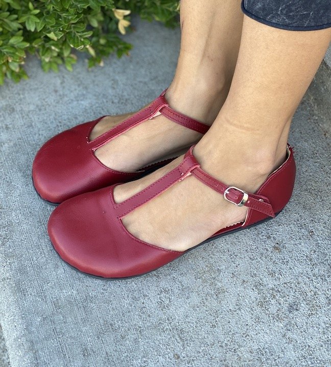 A close up view of a pair of feet wearing stylish women's barefoot dress shoes from Zlatush