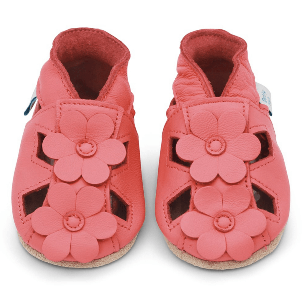 A pair of barefoot coral leather baby soft sole shown on a white background