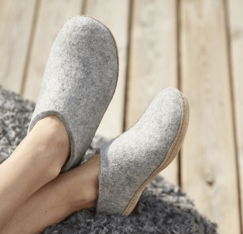 stock photo of Glerups wool slippers worn on a pair of relaxed crossed feet