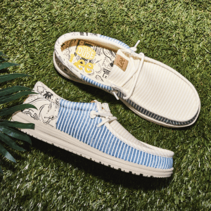 Hey Dude wide toe box stock photo of shoes laying top and side facing up on grass