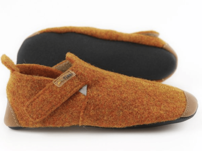 stock photo of burnt orange felted wool barefoot indoor slippers from Tikki Shoes